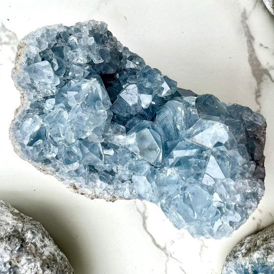 Celestite featured on a marble background.