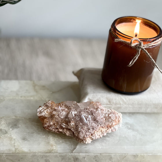 Candle and crystal on a marble surface