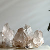 Pink Himalayan Samadhi Quartz pieces with a neutral blurred background.
