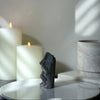 Crystal with candles on a white surface, soft lighting